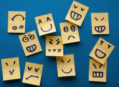 stock-photo-20561098-smilies-yellow-stickers-on-blue-background[1]